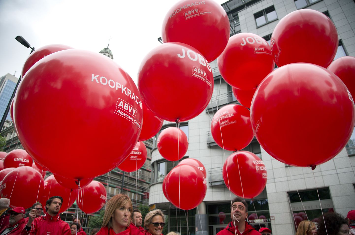 Union members hold balloons which read 'Jobs' and 'Purchasing power' during a demonstration in Brussels on Tuesday, May 24, 2016. Tens of thousands of demonstrators marched through the center of the capital to protest the center-right government