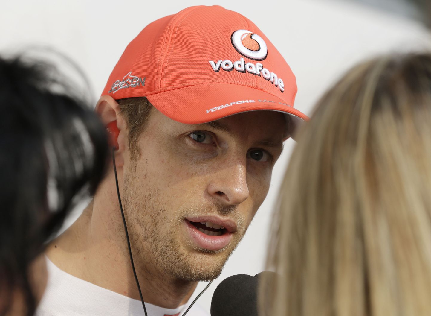 McLaren driver Jenson Button of Britain talks to reporters in the F1 paddock after he crashed out of the Korean Formula One Grand Prix at the Korean International Circuit in Yeongam, South Korea, Sunday, Oct. 14, 2012. (AP Photo/Mark Baker) / SCANPIX Code: 436