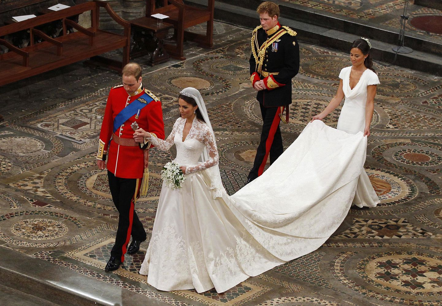 Britain's Prince William (L) and Catherine, Duchess of Cambridge, walk up the aisle followed by Prince Harry and Maid of Honour Pippa Middleton after their wedding ceremony in Westminster Abbey in central London in this April 29, 2011 file photo. Kate Middleton's wedding dress, created by Sarah Burton for the Alexander McQueen label and one of the most talked about outfits of the decade, will go on public display this summer at Buckingham Palace, officials said on June 6, 2011.       To match Reuters Life! BRITAIN-MIDDLETON/DRESS      REUTERS/Kirsty Wigglesworth/Pool/Files (BRITAIN - Tags: FASHION ROYALS)