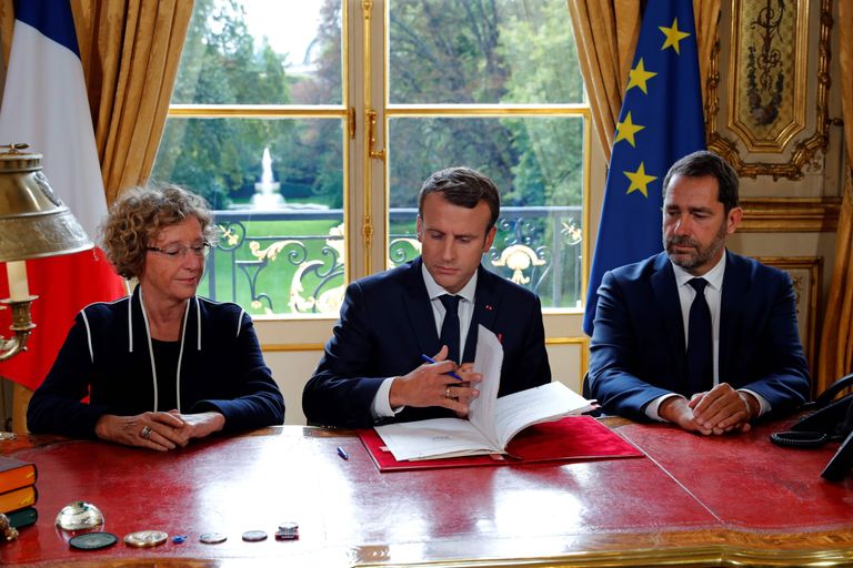 Prantsuse president Emmanuel Macron (keskel), tööminister Muriel Penicaud (vasakul) ja valitsuse pressiesindaja Christophe Castaner (paremal) seadusemuudatuste allkirjastamisel. Foto: Philippe Wojazer/AFP