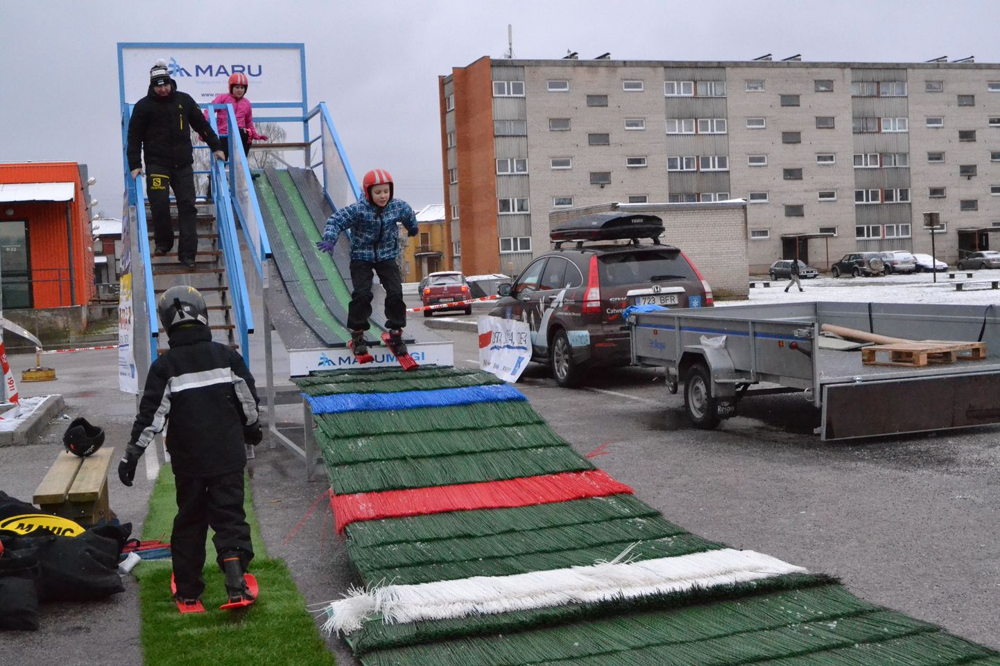 Lapsed proovisid Viljandi Maksimarketi parklas teisaldataval trampliinil suusahüppeid.