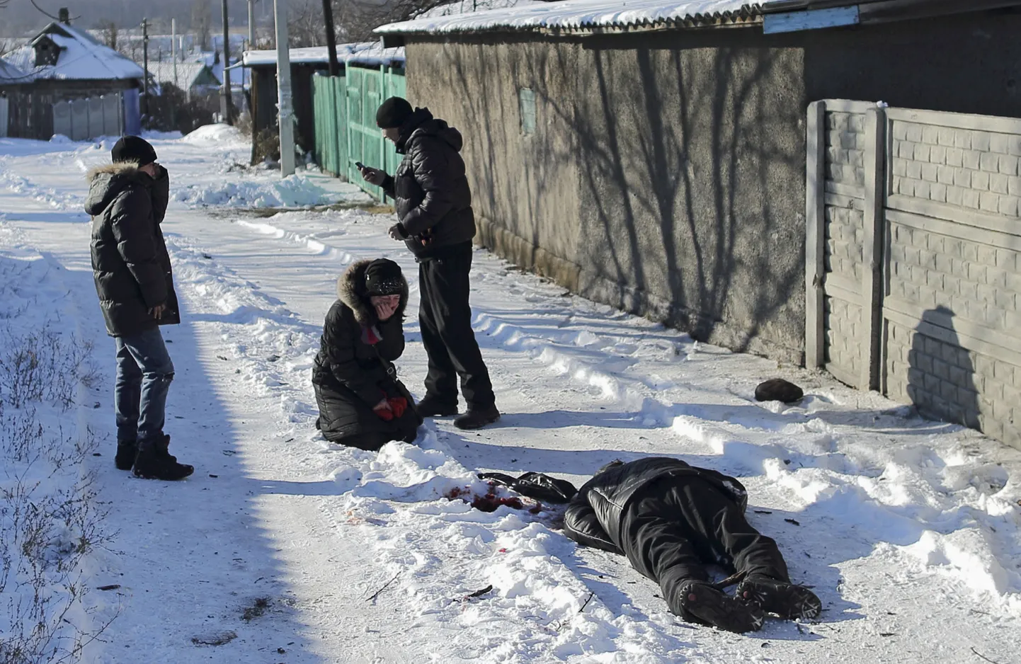 ATTENTION EDITORS - VISUAL COVERAGE OF SCENES OF INJURY OR DEATH 

Galina Bayeva cries with her son (L) and husband (R) next to the body of her father Vladimir Churilov who was killed by recent shelling at the Azotny district in Donetsk, eastern Ukraine, December 5, 2014. Bayeva's parents were out walking in the neighbourhood when they were hit by a shelling attack, leaving her father dead and her mother with severe injuries. REUTERS/Antonio Bronic (UKRAINE - Tags: CIVIL UNREST POLITICS SOCIETY CONFLICT) TEMPLATE OUT