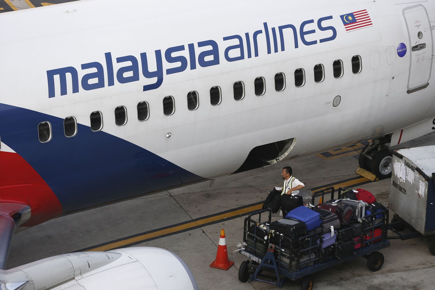 Malaysia Airlinesi töötaja pagasit maha laadimas