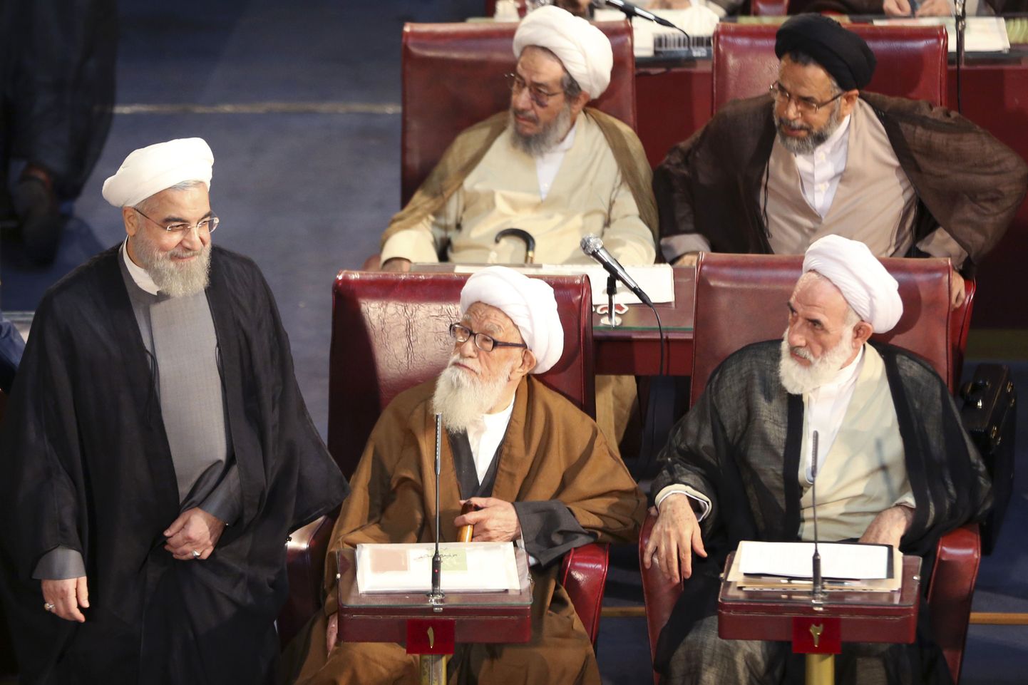 Iranian President Hassan Rouhani, left, who is also a member Experts Assembly, arrives at a biannual meeting of the assembly in Tehran, Iran, Tuesday, Sept. 1, 2015. The 86-member all-cleric assembly is charged with choosing or dismissing the nation's supreme leader, the highest-ranking official who has the final say on all state matters. (AP Photo/Vahid Salemi)