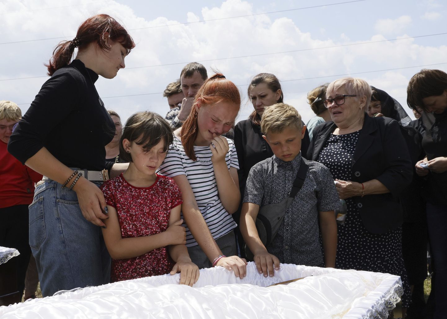 Дети плачут у гробов 14-летних близнецов Анны Аксенченко и Юлии Аксенченко, погибших в результате ракетного удара по пиццерии в Краматорске, Доброполье Донецкая область, Украина, 30 июня 2023 года.