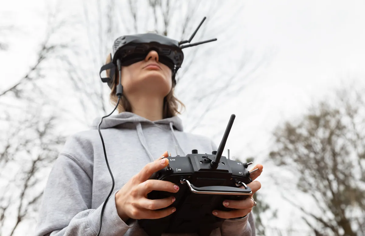 Building on the success of unmanned systems across land, air, and maritime domains, Ukraine has established an unmanned systems command. In Lviv, a young woman dons virtual reality goggles and holds a remote control as she learns to pilot an FPV drone.