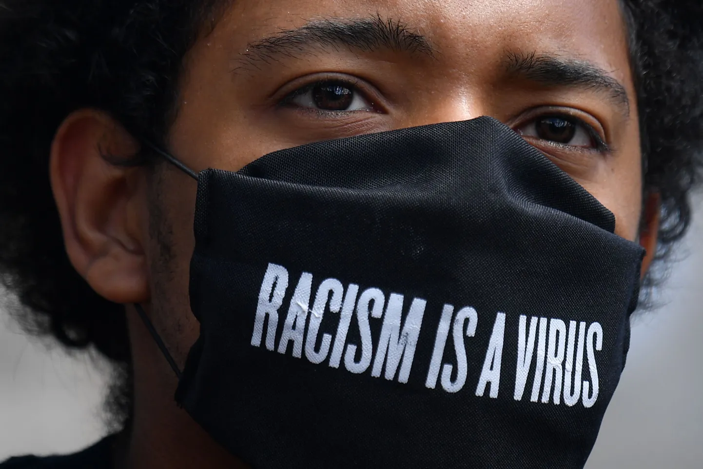 Meeleavaldaja kannab maski, millel on kiri «Rassism on viirus», Londonis 5. juulil 2020.