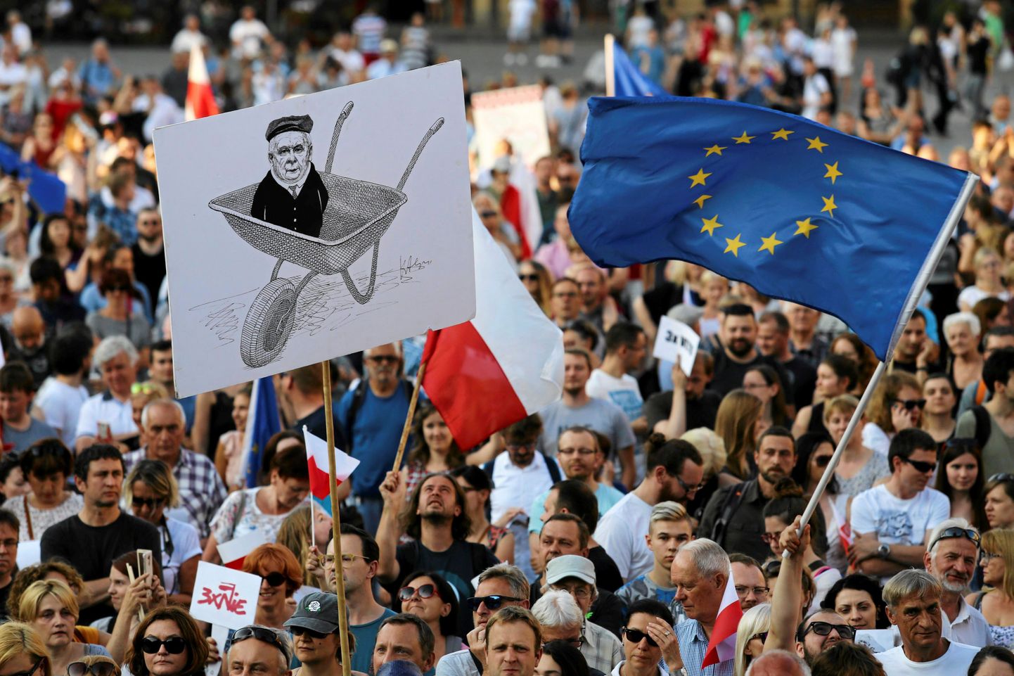 People hold a caricature of Jaroslaw Kaczynski, depicted on a wheelbarrow, as they gather during a protest against the Supreme Court legislation at the Main Square in Krakow, Poland, July 22, 2017. Agencja Gazeta/Jakub Porzycki  via REUTERS ATTENTION EDITORS - THIS IMAGE HAS BEEN SUPPLIED BY A THIRD PARTY. POLAND OUT. NO RESALES. NO ARCHIVES.