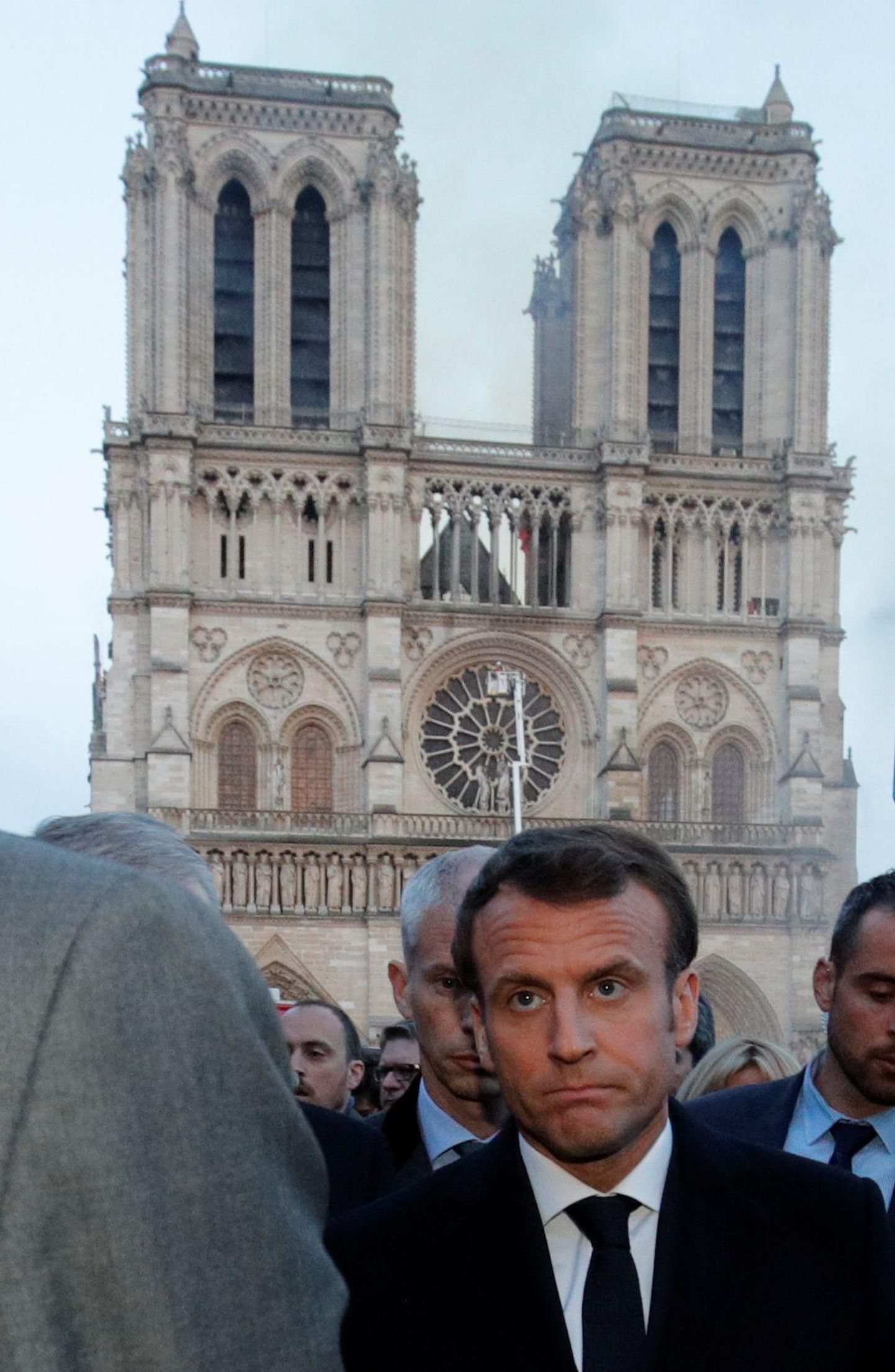 Prantsuse president Emmanuel Macron eile hommikul suitsevate Jumalaema kiriku varemete juures. 