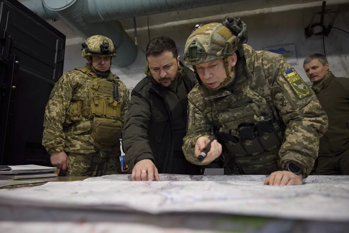 Ukraine's new defense chief General Syrskyi (R) tends to lead from the front. Ukrainian President Volodymyr Zelenskyy, center, is briefed on the situation along the Kupyansk-Lyman defensive line.