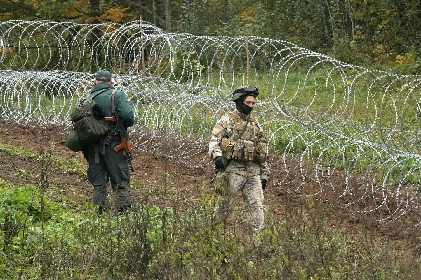 Läti piirivalvur ja kaitseväelane valvavad piiri.