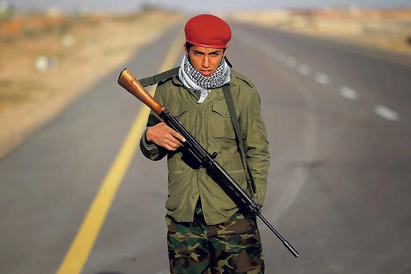 Liibüa mässuline võitleja valvamas viimast kontrollpunkti teel, mis viib Bin Jawadist Nawfiliyah’sse.