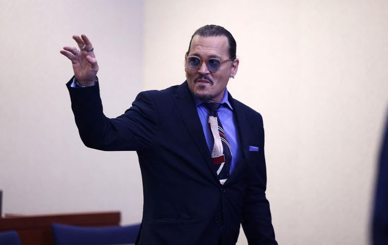US actor Johnny Depp waves as he departs at the end of the day during his defamation case against ex-wife, actor Amber Heard in Fairfax, Virginia, U.S., May 5, 2022. Jim Lo Scalzo/Pool via REUTERS