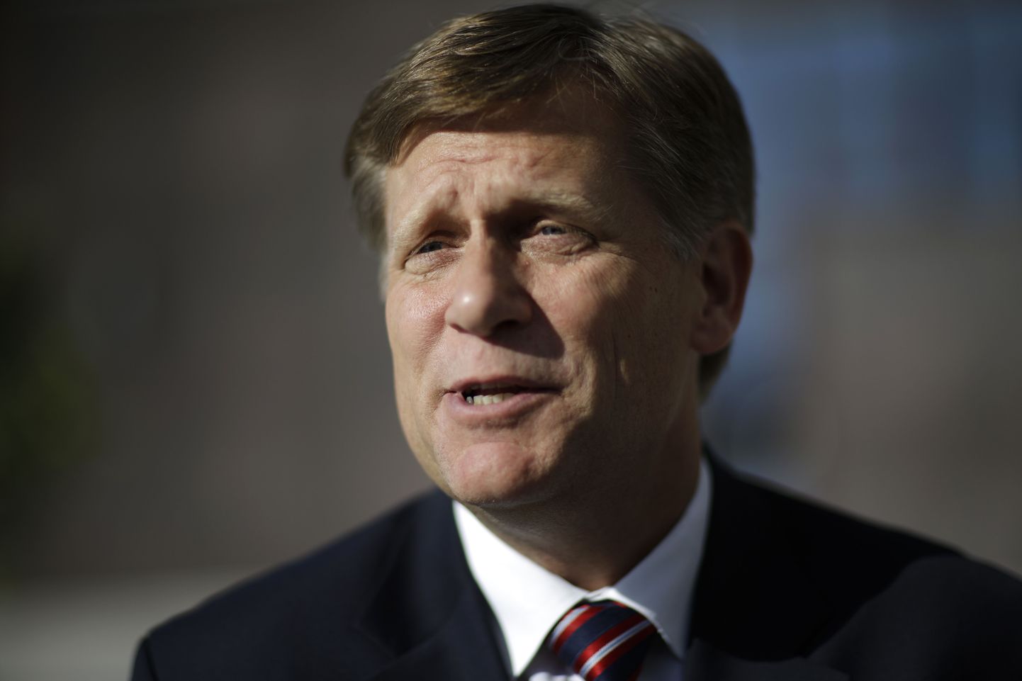 FILE - In this Feb. 7, 2014 file photo, Michael McFaul speaks with a reporter in Sochi, Russia. McFaul, the former U.S. ambassador to Russia said Friday, Nov. 11, 2016, that he has been banned from traveling there in a tit-for-tat response to U.S. visa bans for senior Russian officials. (AP Photo/David Goldman, File)