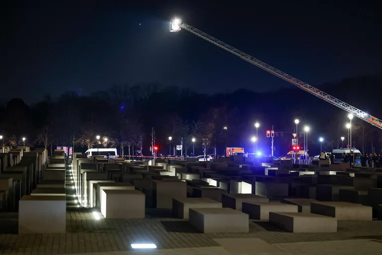 Members of the emergency services use a crane as they work at the scene where a person was stabbed near the memorial of the murdered jews of Europe in Berlin on February 21, 2025