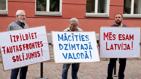 Foto ⟩ Aptuveni 50 cilvēku pie Saeimas protestē pret pāreju uz mācībām latviešu valodā