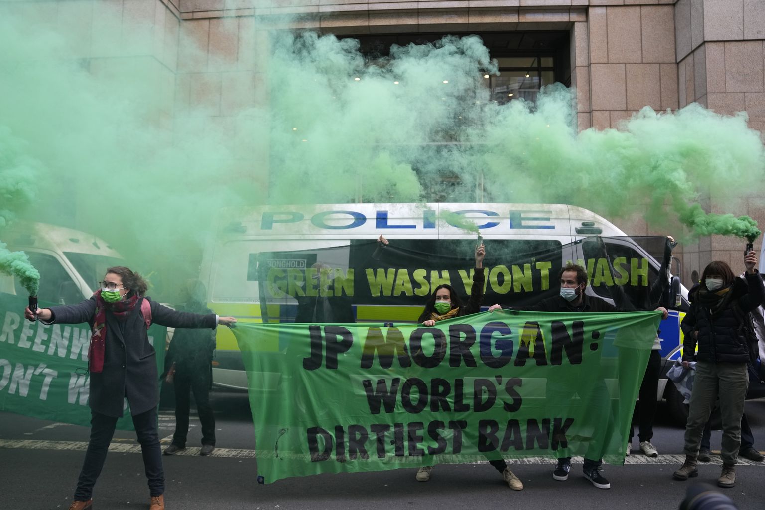 Extension Rebellion activists protest in front of JP Morgan premises as they take part in a demonstration against 'Greenwashing' near the COP26 U.N. Climate Summit in Glasgow, Scotland, Wednesday, Nov. 3, 2021.
