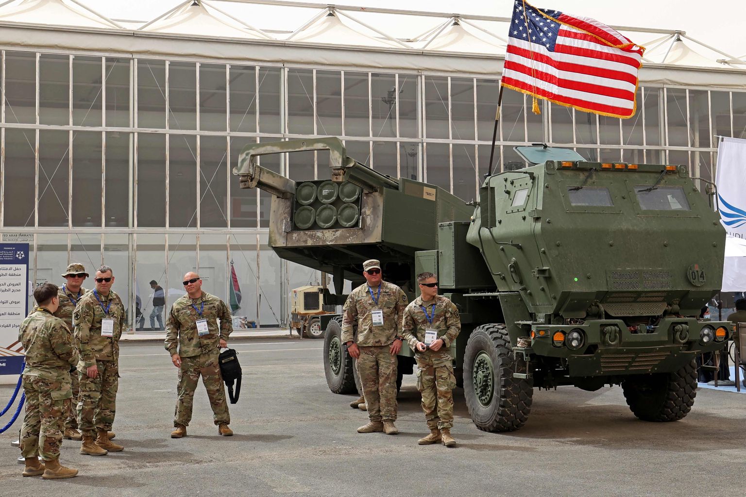 US military personnel stand by a M142 High Mobility Artillery Rocket System (HIMARS).