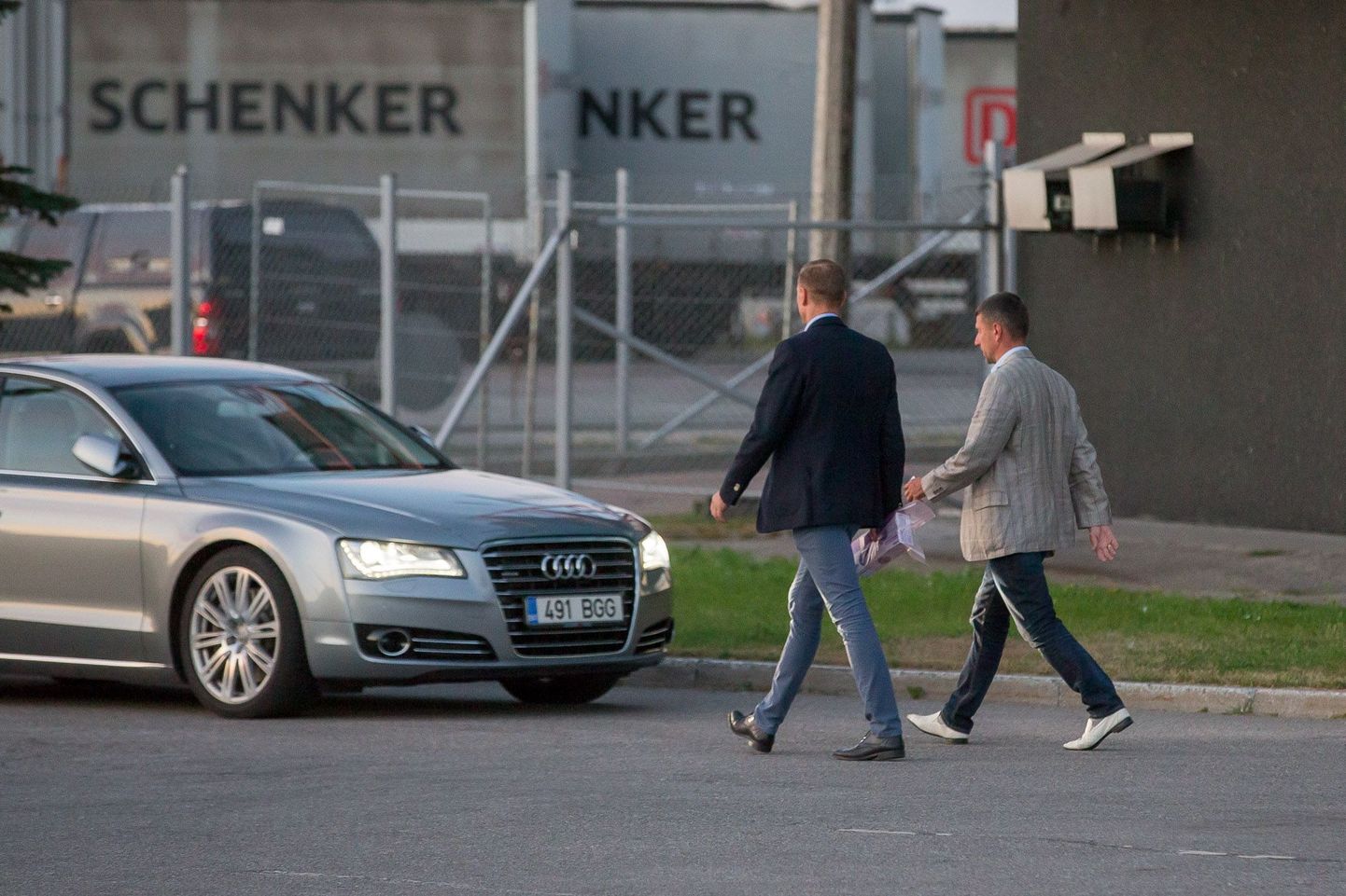 Tallinna Sadama endine juhatuse esimees Ain Kaljurand (paremal) suundumas kinnipidamise järel kaitsepolitsei ametniku saatel oma sõiduki juurde. Foto tehtud 2015. aasta 26. augustil.