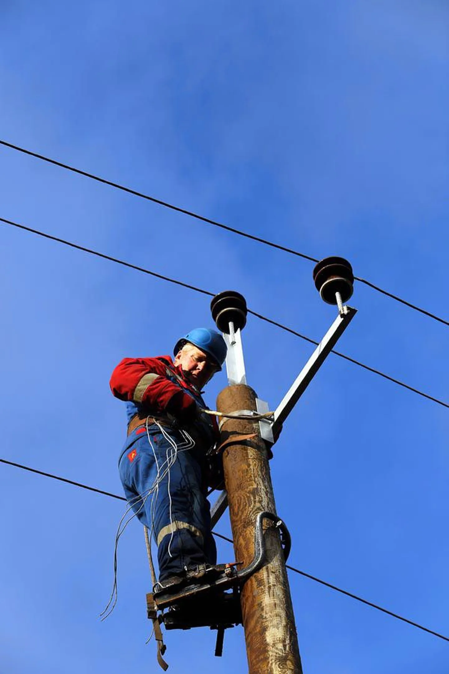 Elektrik Rein Hiob vallutab ühe elektrimasti teise järel, et uutel postidel taas elektriliini juhtmed isolaatorite külge kinnitada. Puust posti otsa ronimiseks on tal spetsiaalsed rauad, mille abil mees hõlpsasti kõlks ja kõlks ülespoole tööd tegema ronib.