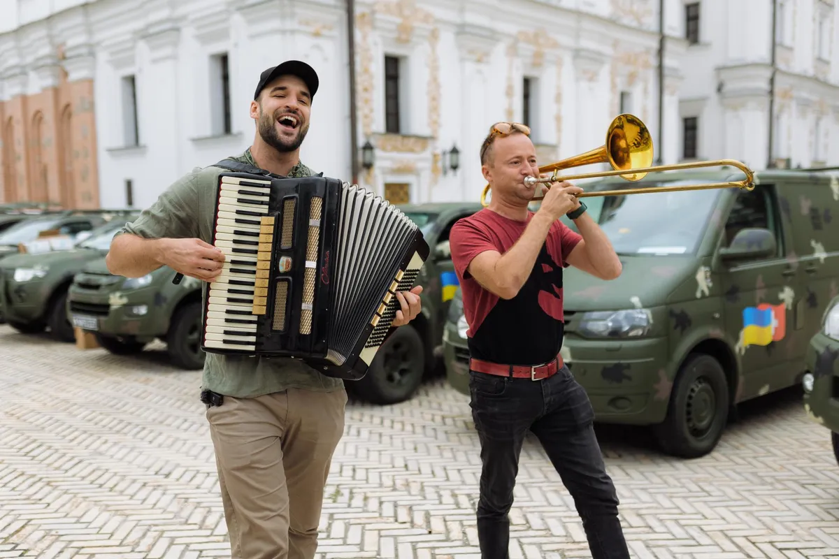 War Blogger Artur Rehi (on the left with accordion) runs a charity artursarmy.com to provide military assistance to Ukraine. Recently he personally delivered minivans and trucks to the Ukranian Special Forces.