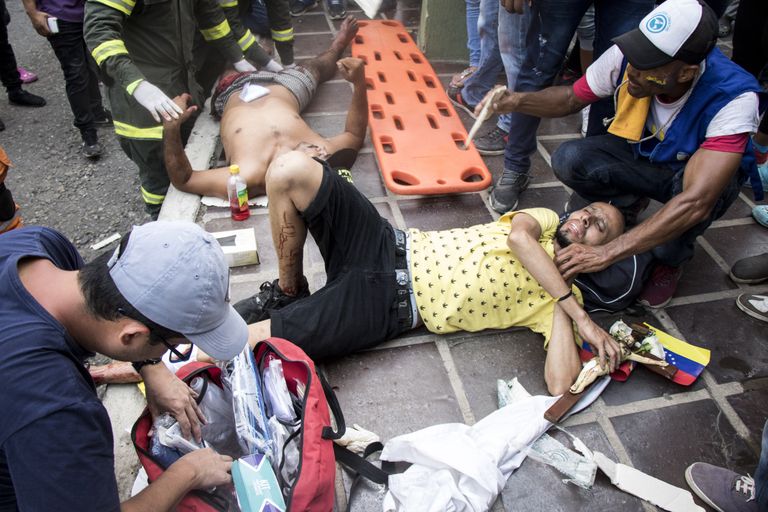 Colombia politseinikud andmas abi meeleavaldajale riiki Venezuelaga ühendaval sillal.
