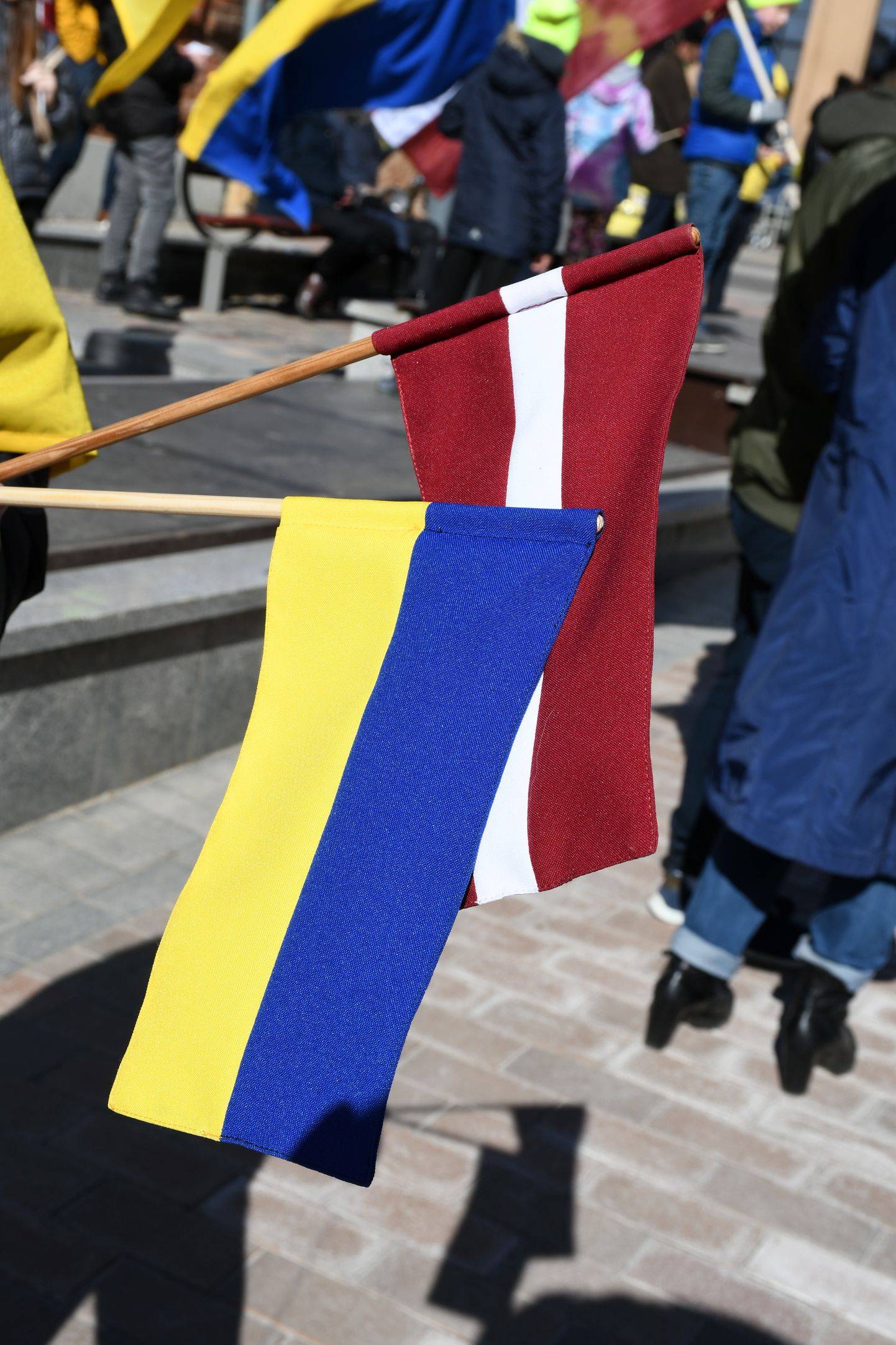Cilvēki pulcējas gājienam "Latvija atbalsta Ukrainu" Daugavpilī pie dzelzceļa stacijas.