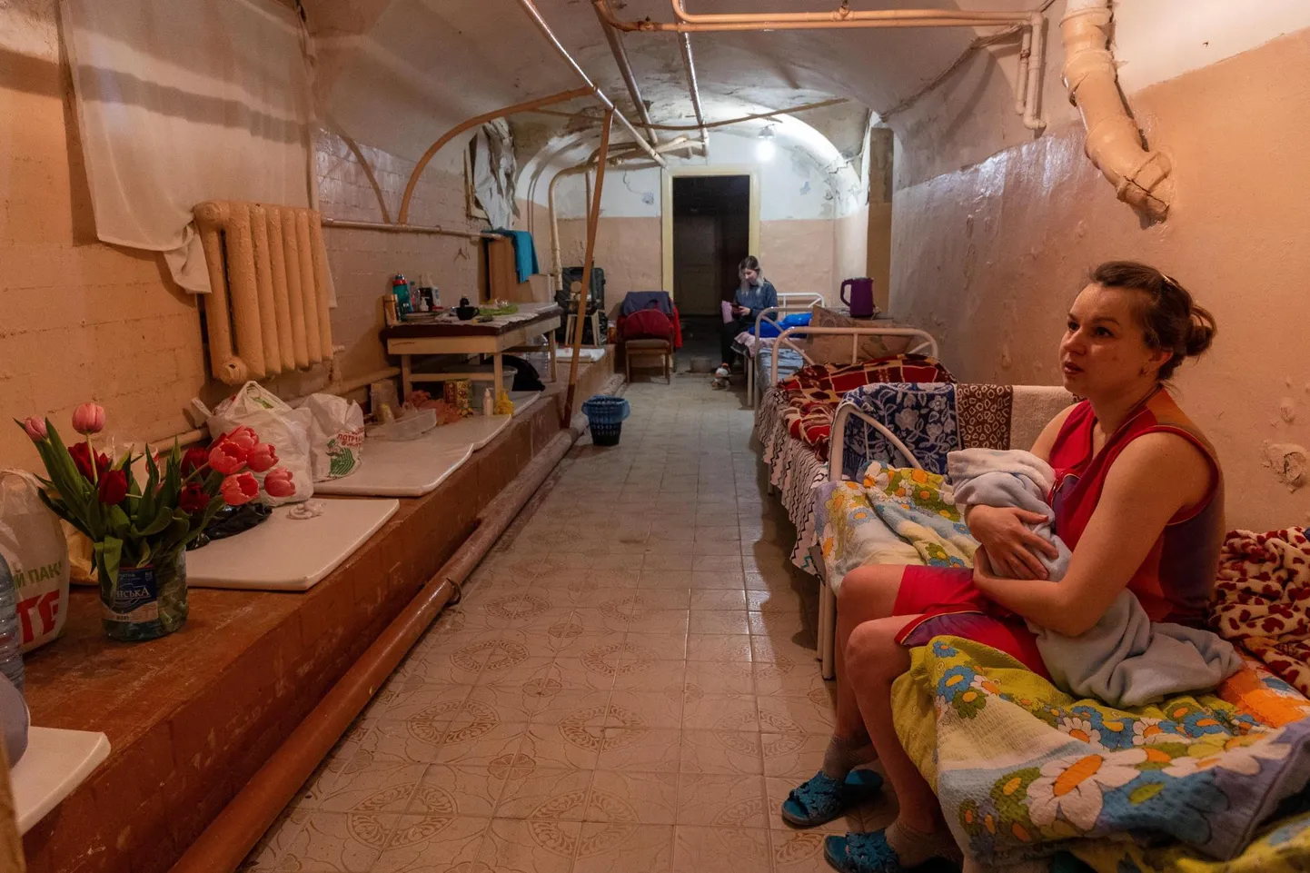 Shelter of Kharkiv maternity hospital. Jana, 32, is holding her three-week-old son, Misha.