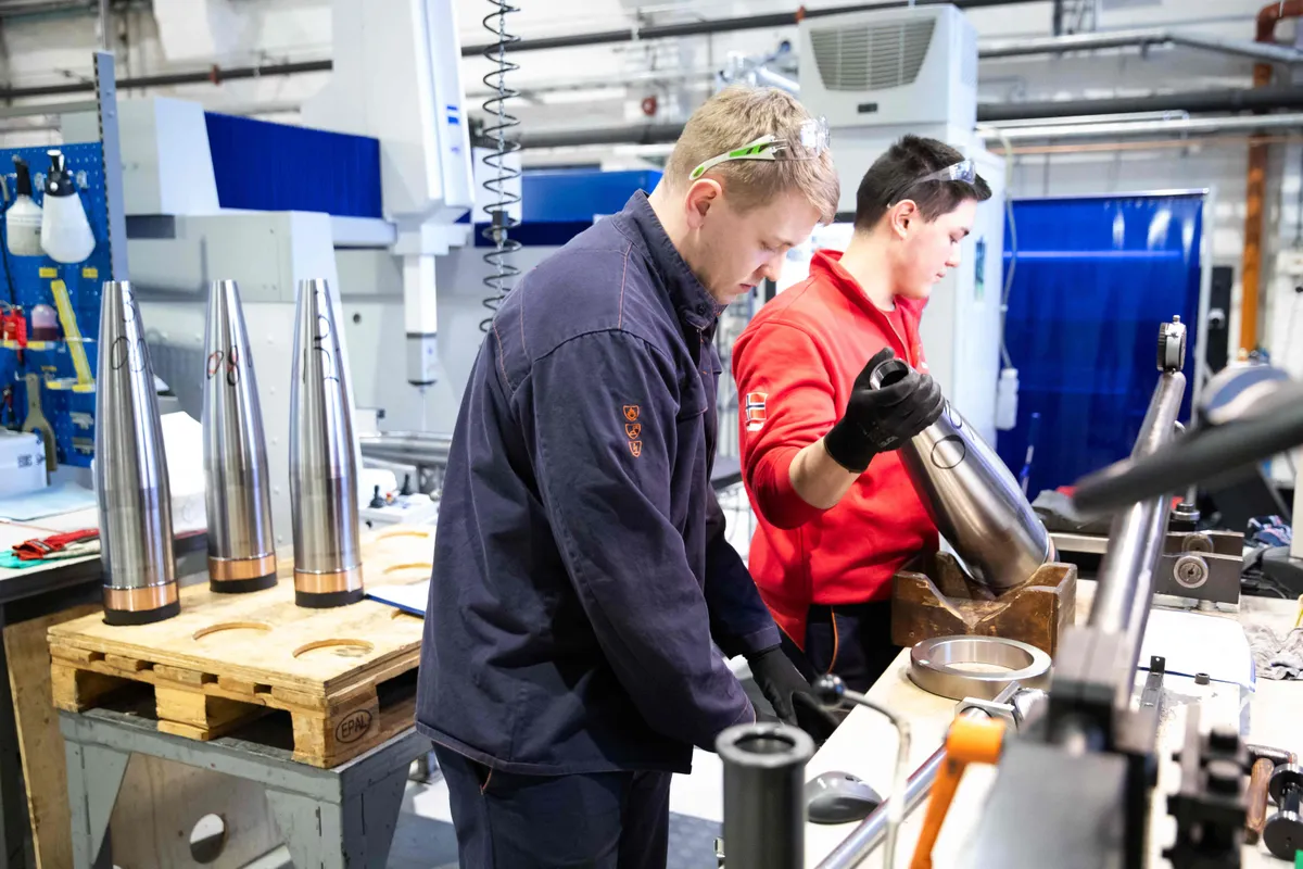 Workers handle empty artillery shells at the production line of weapons manufacturer Nammo, on January 17, 2024 in Raufoss, Norway.