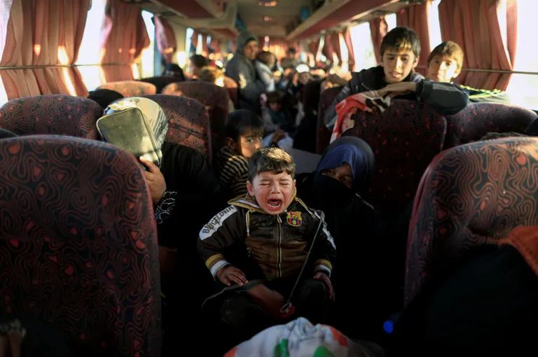A boy, who just fled a village controlled by Islamic State fighters cries as he sits with his family inside a bus before heading to the camp at Hammam Ali south of Mosul, Iraq February 22, 2017. REUTERS/Zohra Bensemra TPX IMAGES OF THE DAY