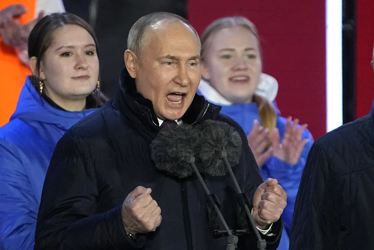 Russian President Vladimir Putin speaks at a concert marking his victory in a presidential election and the 10-year anniversary of Crimea's annexation by Russia on Red Square in Moscow, Russia, Monday, March 18, 2024.