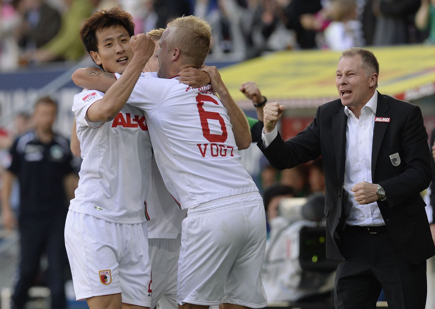 (L-R) Augsburg's Korean midfielder Dong-Won Ji, Augsburg's midfielder Kevin Vogt and Augsburg's manager Stefan Reuter celebrate after the third goal for Augsburg during the German first division Bundesliga match between FC Augsburg and Greuther Fuerth in Augsburg, southern Germany, on May 18, 2013. Augsburg won the match 3-1.      AFP PHOTO / CHRISTOF STACHE

DFL RULES TO LIMIT THE ONLINE USAGE DURING MATCH TIME TO 15 PICTURES PER MATCH. IMAGE SEQUENCES TO SIMULATE VIDEO IS NOT ALLOWED AT ANY TIME. FOR FURTHER QUERIES PLEASE CONTACT DFL DIRECTLY AT + 49 69 650050.