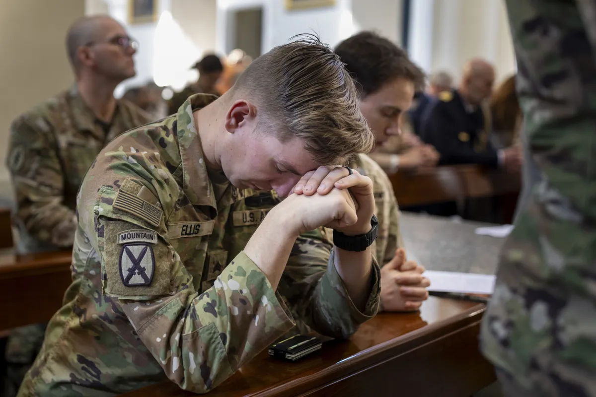 U.S. soldiers pray as they attend a Holy Mass for the four U.S. soldiers who went missing during exercises conducted by the United States at the Pabrade training ground, at the Cathedral Basilica in Vilnius, Lithuania, Sunday, March 30, 2025.