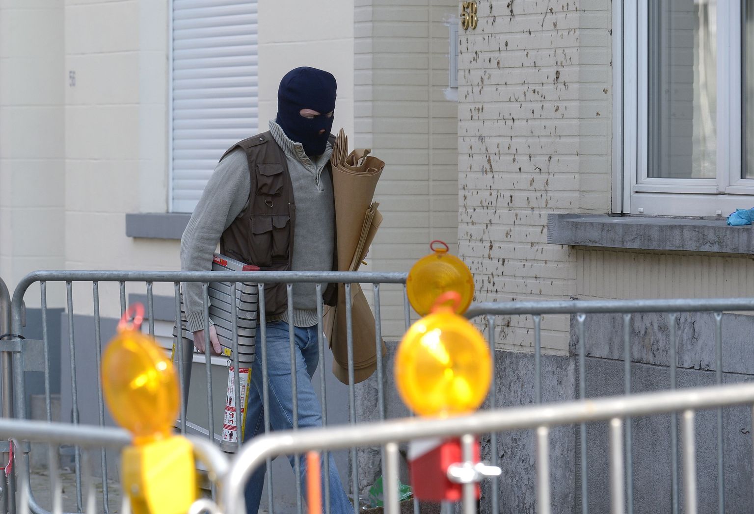 Maskis politseinik Brüsselis maja ees, kus politsei pidas teisipäeval kurjategijatega maha tulevahetuse.