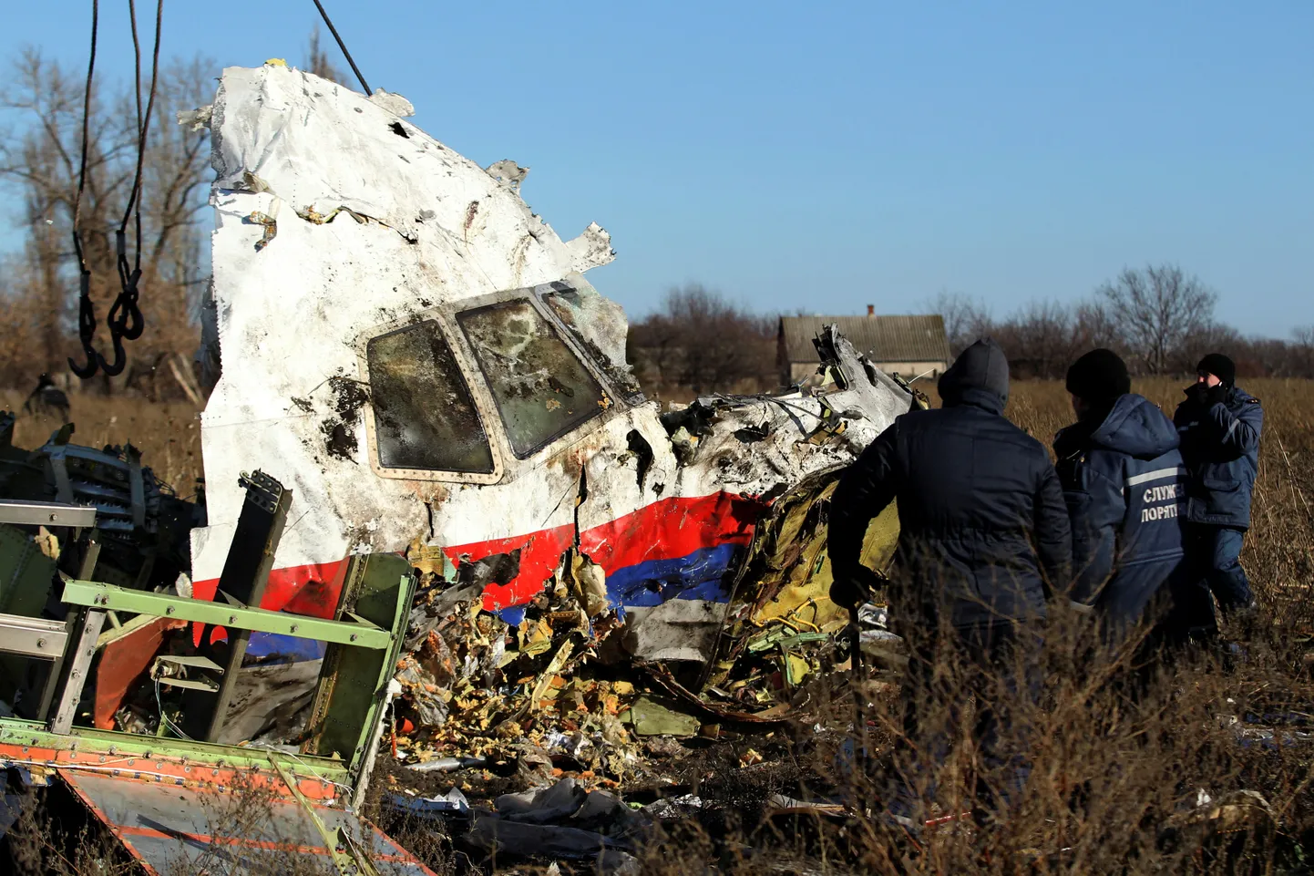Local workers transport a piece of wreckage from Malaysia Airlines flight MH17