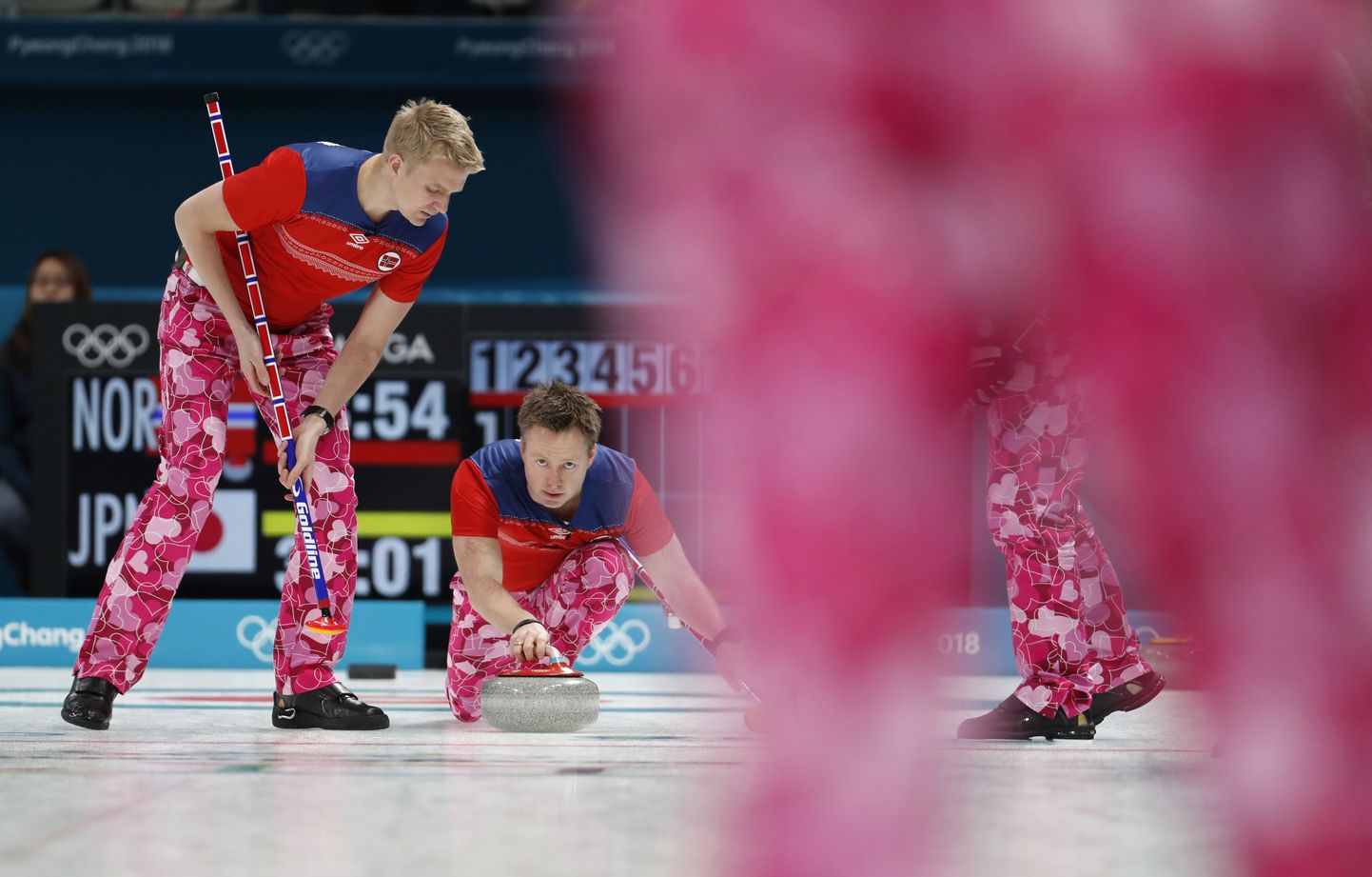 Curling – Pyeongchang 2018 Winter Olympics – Men Round Robin - Norway v Japan - Gangneung Curling Center - Gangneung, South Korea – February 14, 2018 - Vice-skip Torger Nergaard of Norway delivers the stone as lead Haavard Vad Petersson of Norway looks on. REUTERS/Cathal McNaughton