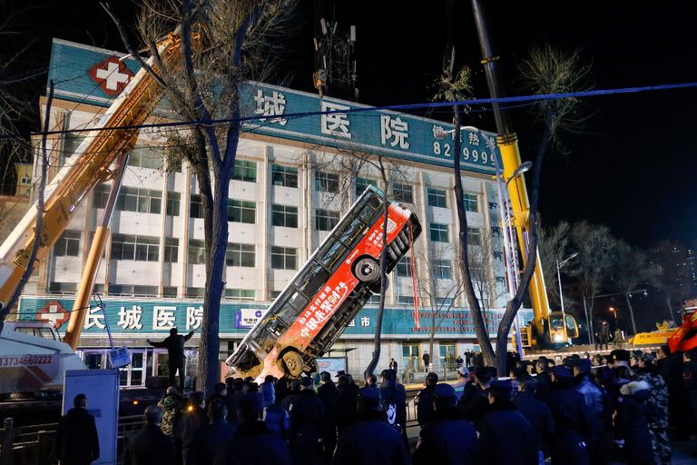 Hiina päästetöötajad tõmbamas Qinghai provintsis Xiningis karstilehtrisse kukkunud bussi välja.