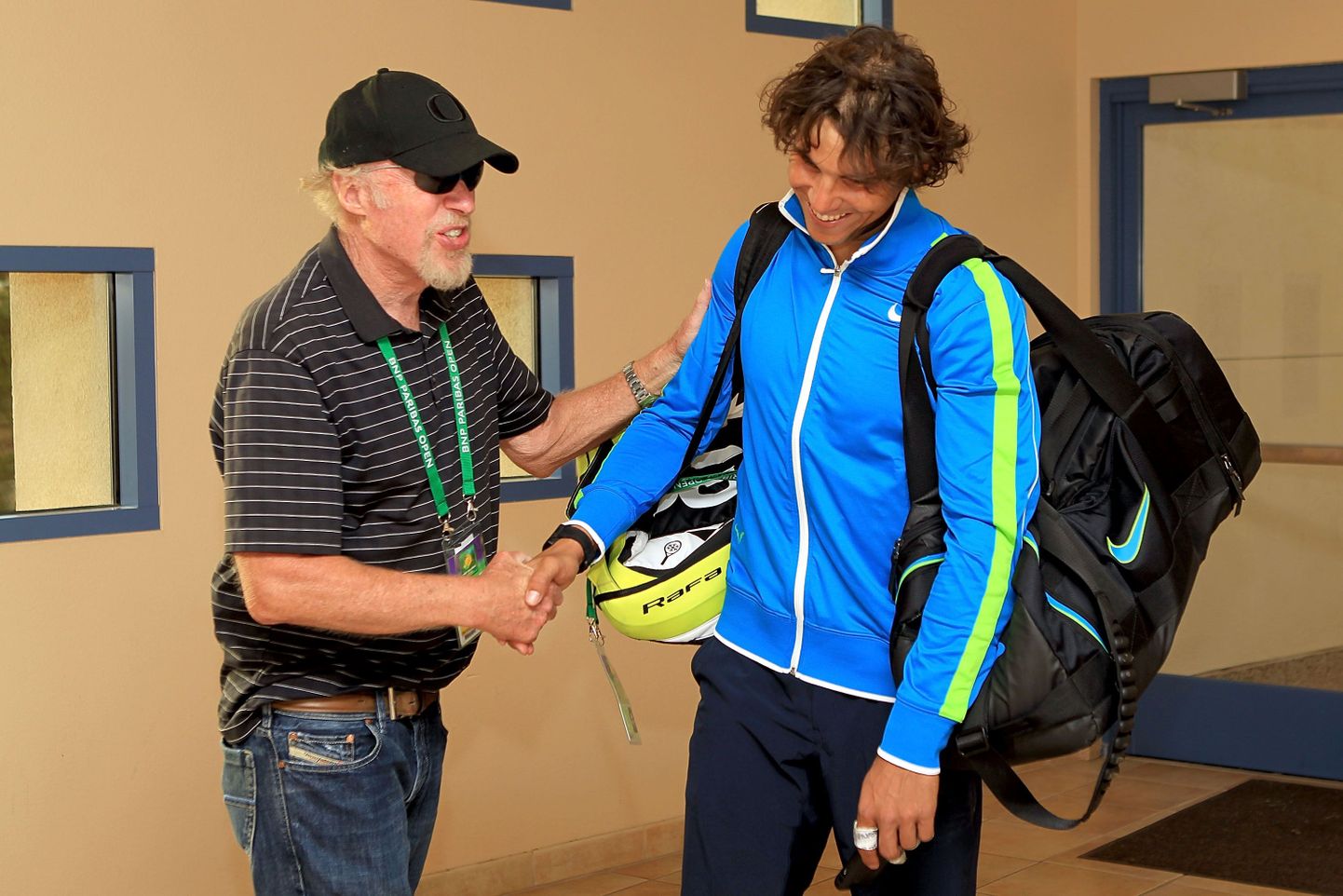 INDIAN WELLS, CA - MARCH 16: Phil Knight, founder and chairman of Nike, congratulates Rafael Nadal of Spain after his win over David Nalbandian of Argentina during the BNP Paribas Open at the Indian Wells Tennis Garden on March 16, 2012 in Indian Wells, California.   Matthew Stockman/Getty Images/AFP