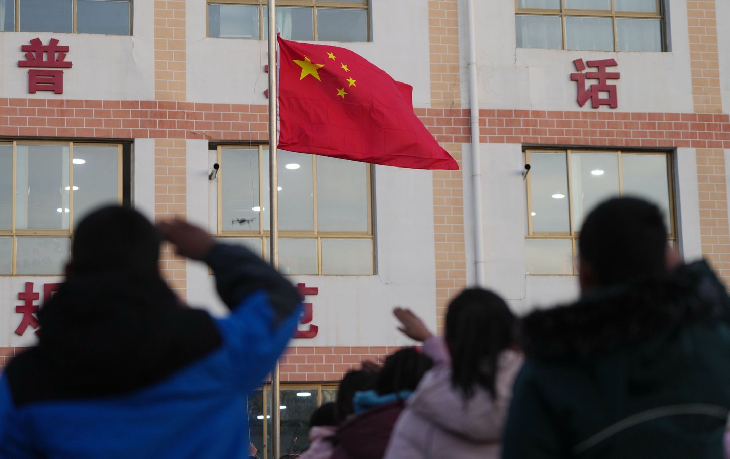 JISHISHAN, Dec. 25, 2023  A flag-raising ceremony is held at a primary school in Liugou Township of Jishishan County, northwest China's Gansu Province, Dec. 25, 2023. Primary and secondary schools in the quake-hit areas of Jishishan started to resume classes on Monday after a safety check. (Credit Image: Â© Chen Bin/Xinhua via ZUMA Press)