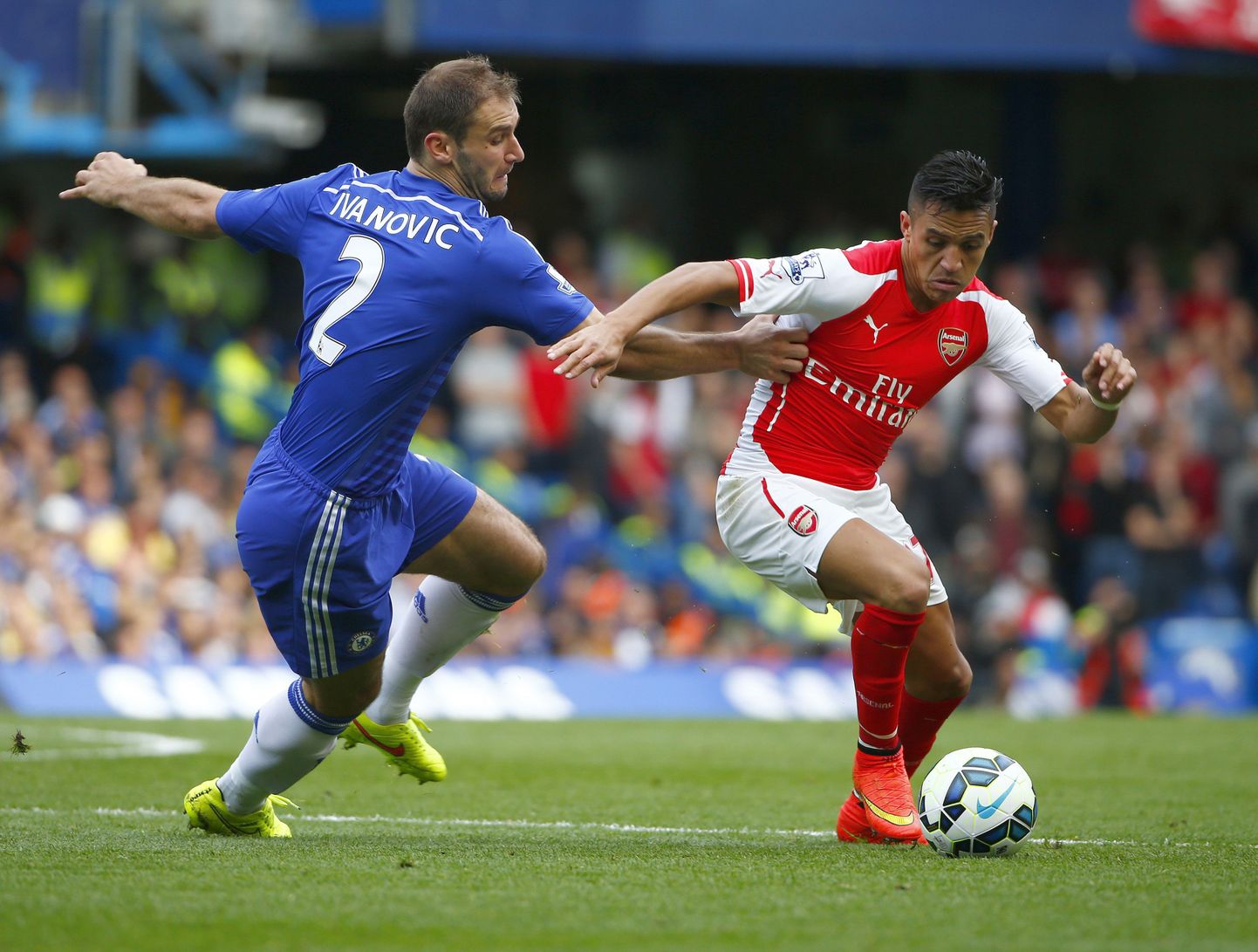 Arsenal's Alexis Sanchez (R) is challenged by Chelsea's Branislav Ivanovic during their English Premier League soccer match at Stamford Bridge in London October 5, 2014. REUTERS/Eddie Keogh  (BRITAIN - Tags: SPORT SOCCER TPX IMAGES OF THE DAY) NO USE WITH UNAUTHORIZED AUDIO, VIDEO, DATA, FIXTURE LISTS, CLUB/LEAGUE LOGOS OR "LIVE" SERVICES. ONLINE IN-MATCH USE LIMITED TO 45 IMAGES, NO VIDEO EMULATION. NO USE IN BETTING, GAMES OR SINGLE CLUB/LEAGUE/PLAYER PUBLICATIONS. FOR EDITORIAL USE ONLY. NOT FOR SALE FOR MARKETING OR ADVERTISING CAMPAIGNS