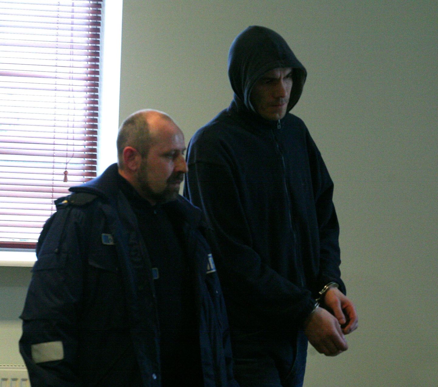 Kahe naise mõrvas süüdistatav Andres Võsu (paremal) politseivalve all Pärnu maakohtus.