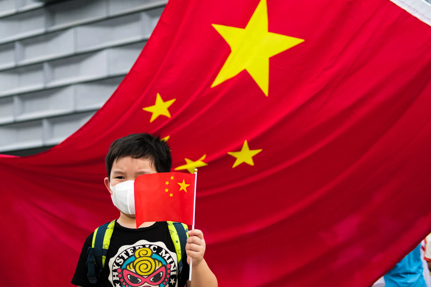 Hiina laps lipuga tähistamas Hiina rahvuspäeva.