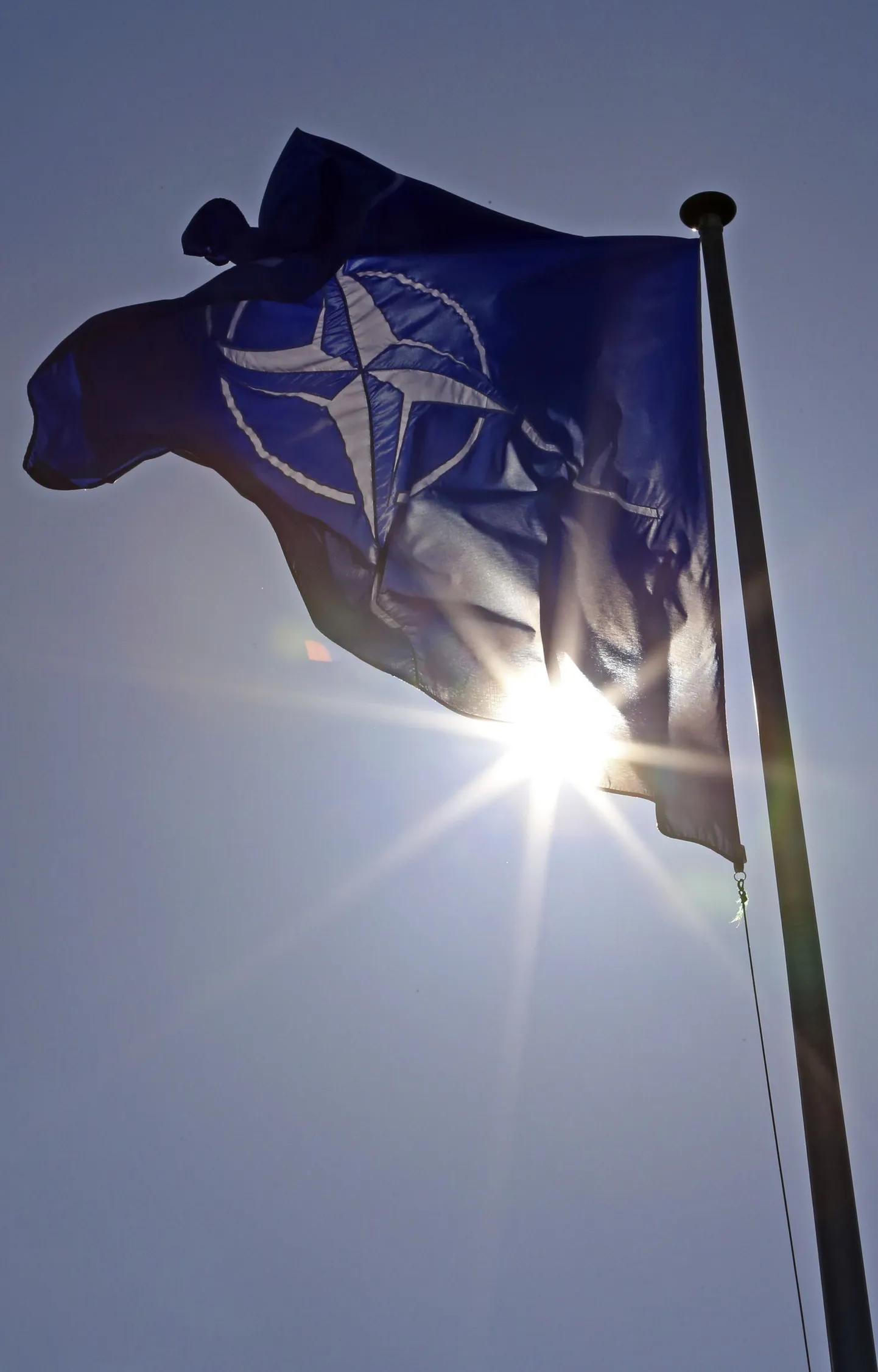 A NATO flag flies at the Alliance headquarters in Brussels during a NATO ambassadors meeting.
