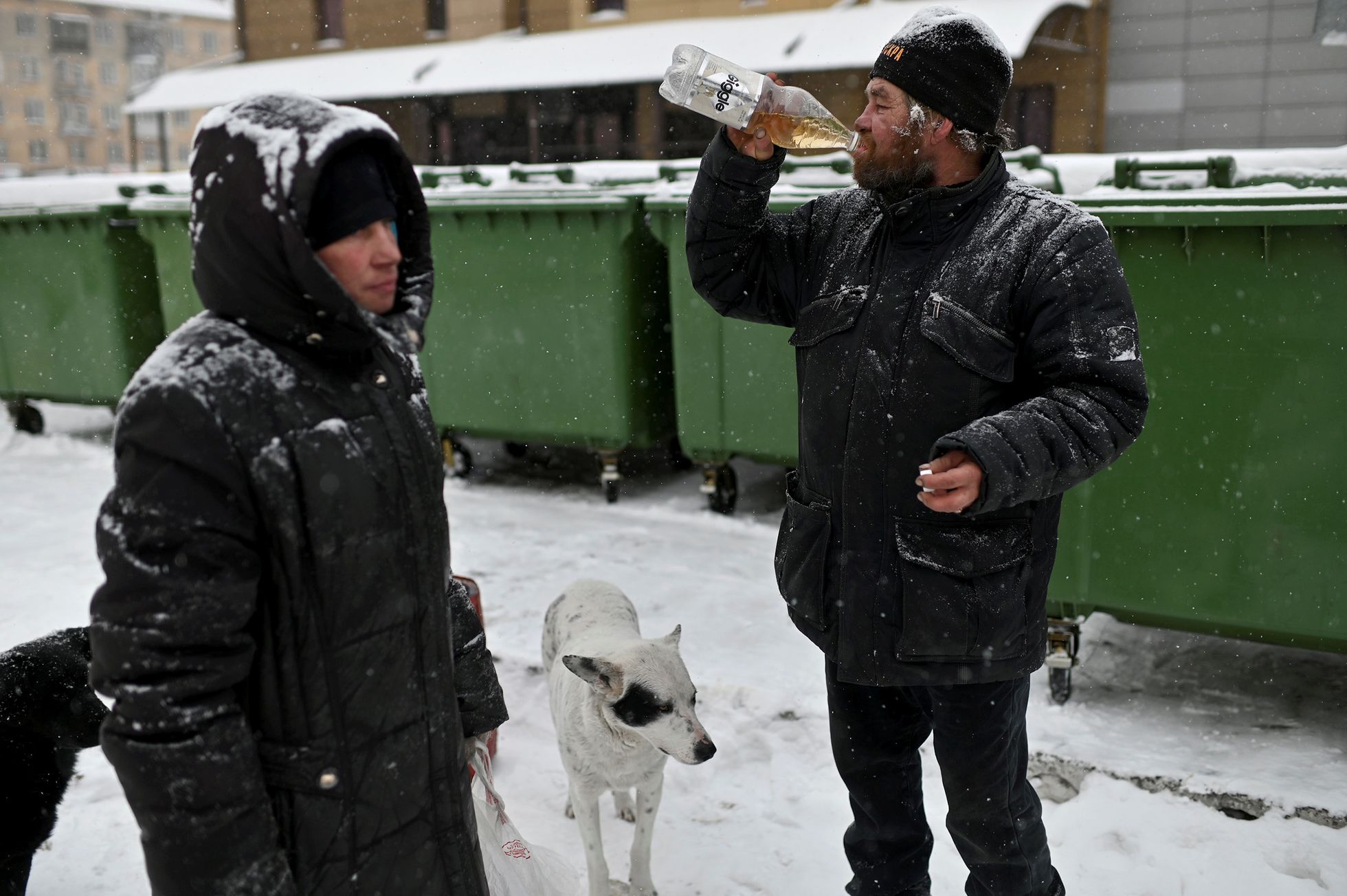 Алексей Вергунов (справа) находит в мусорнике недопитую бутылку и опустошает ее. Рядом с ним его приятель Александр.