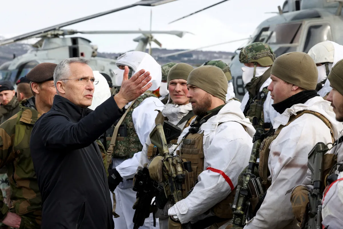 NATO Secretary General Jens Stoltenberg interacts with Dutch Marines as part of a military exercise called "Cold Response 2022" at a base in Bardufoss in the Arctic Circle, Norway, March 25, 2022. REUTERS